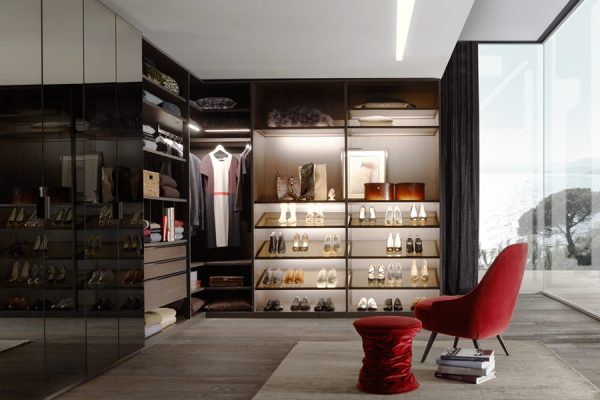 Open wardrobe in bedroom with women’s shoes
