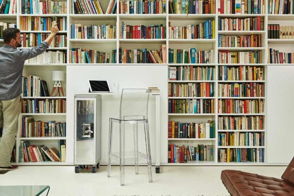 Silver BordBar trolley in front of a wall-to-wall library bookshelf, elegant setting.