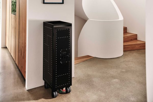 Black BordBar trolley placed next to a staircase, minimalistic modern interior.