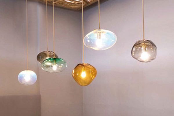 Cluster of ELOA glass pendant lights arranged over dining table