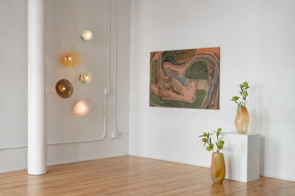 ELOA wall-mounted glass sculptures with art painting and vases on display