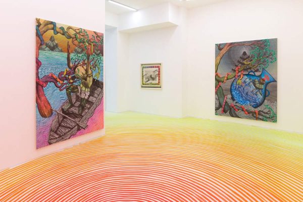 Art display with expressive paintings on both walls and patterned gallery floor