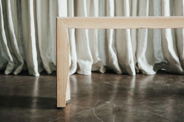 Frontal view of a minimalist wooden bench – clean design with natural finish.