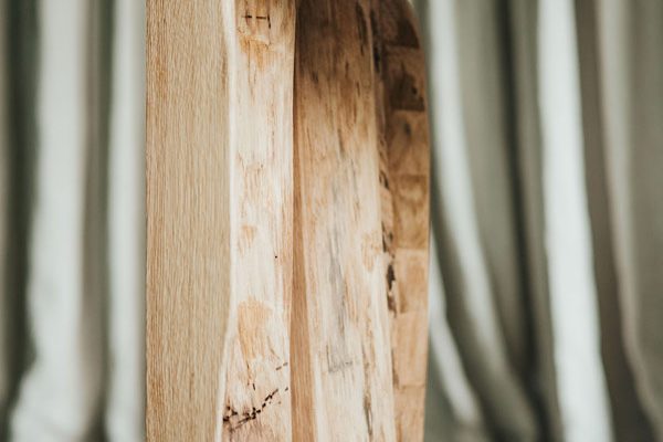 Side detail of a handcrafted wooden bench – angled view showing smooth edges and craftsmanship.