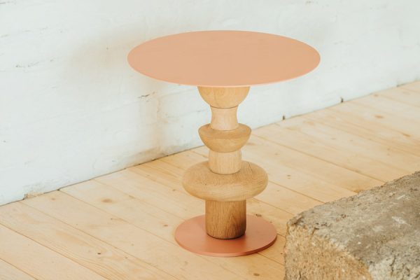 Small round wooden side table with a natural finish – minimalist design by NIROH.