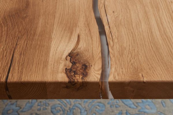 Detail of a natural wood tabletop with clear epoxy resin fill – PLH design
