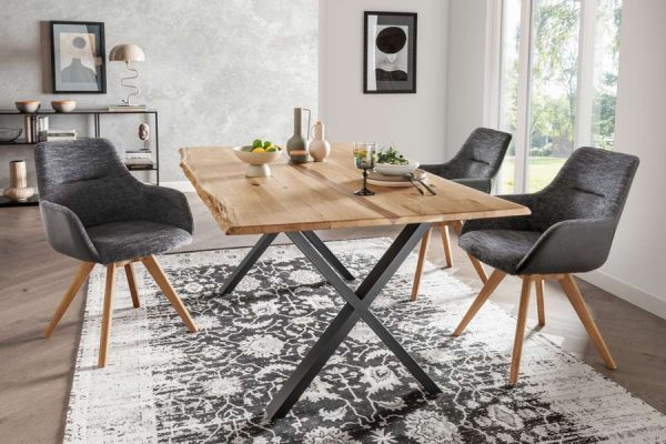 Solid wood dining table with black metal cross legs and matching chairs by PLH