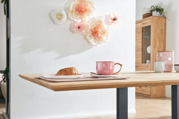 Extended dining table by PLH showing pull-out tabletop function