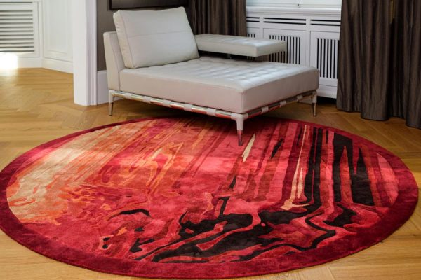 Round red designer carpet in a contemporary setting, featuring dynamic vertical textures – part of the 'Daydreams' collection by Olaf Kitzig.