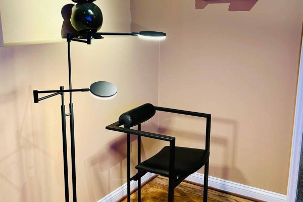 518 North showroom – minimalist black metal chair and modern Holtkötter floor lamp in a warm beige interior corner